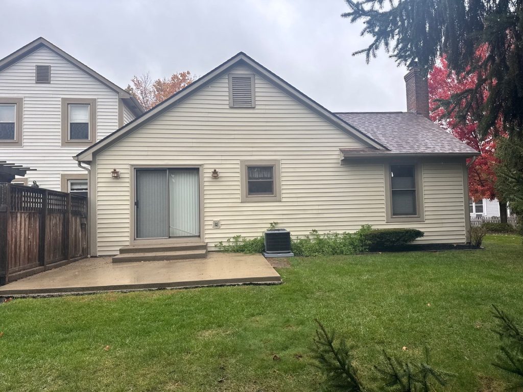 Rear residential yard with patio and lawn prepared for commercial-grade drainage improvements in Central Ohio.